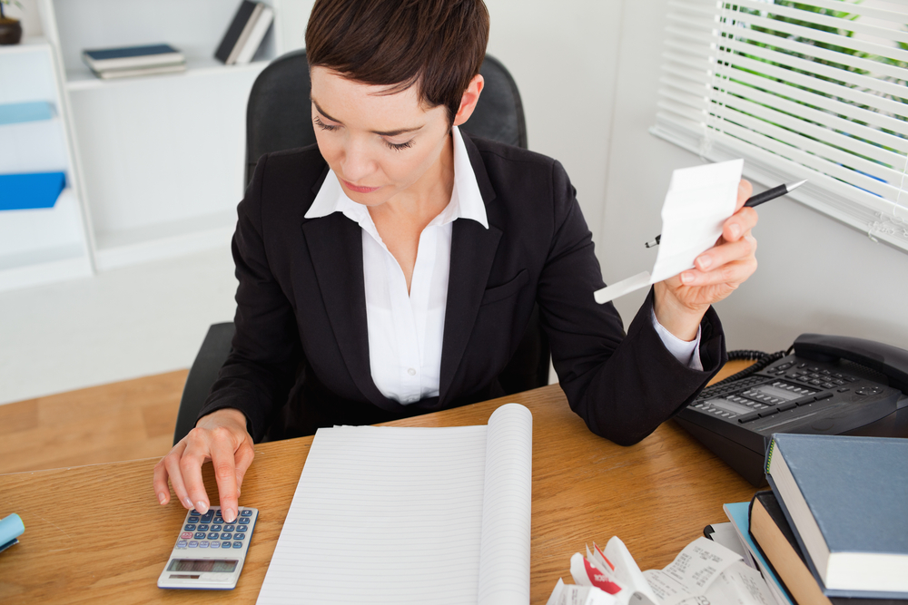 business woman checking receipts in her office