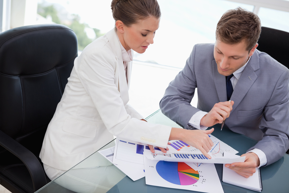 Woman helping man with accounting