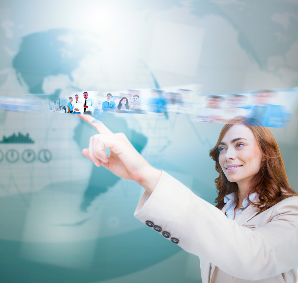 Smiling businesswoman scrolling pictures on blue map background