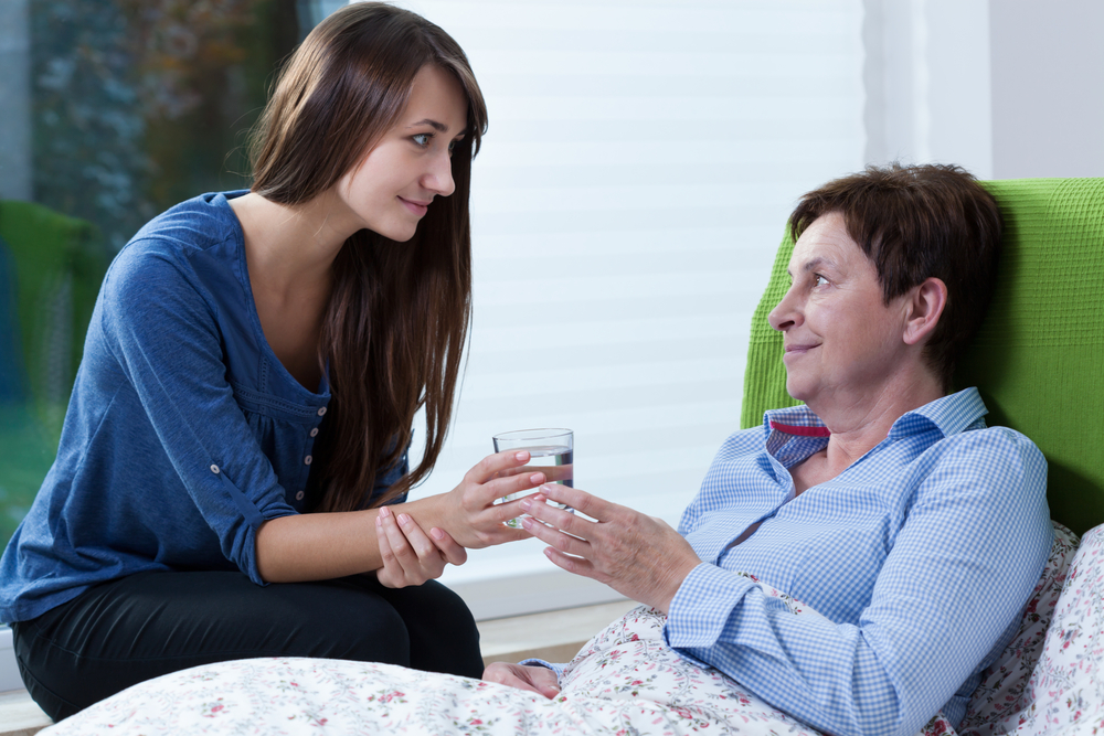 Woman helping elderly woman