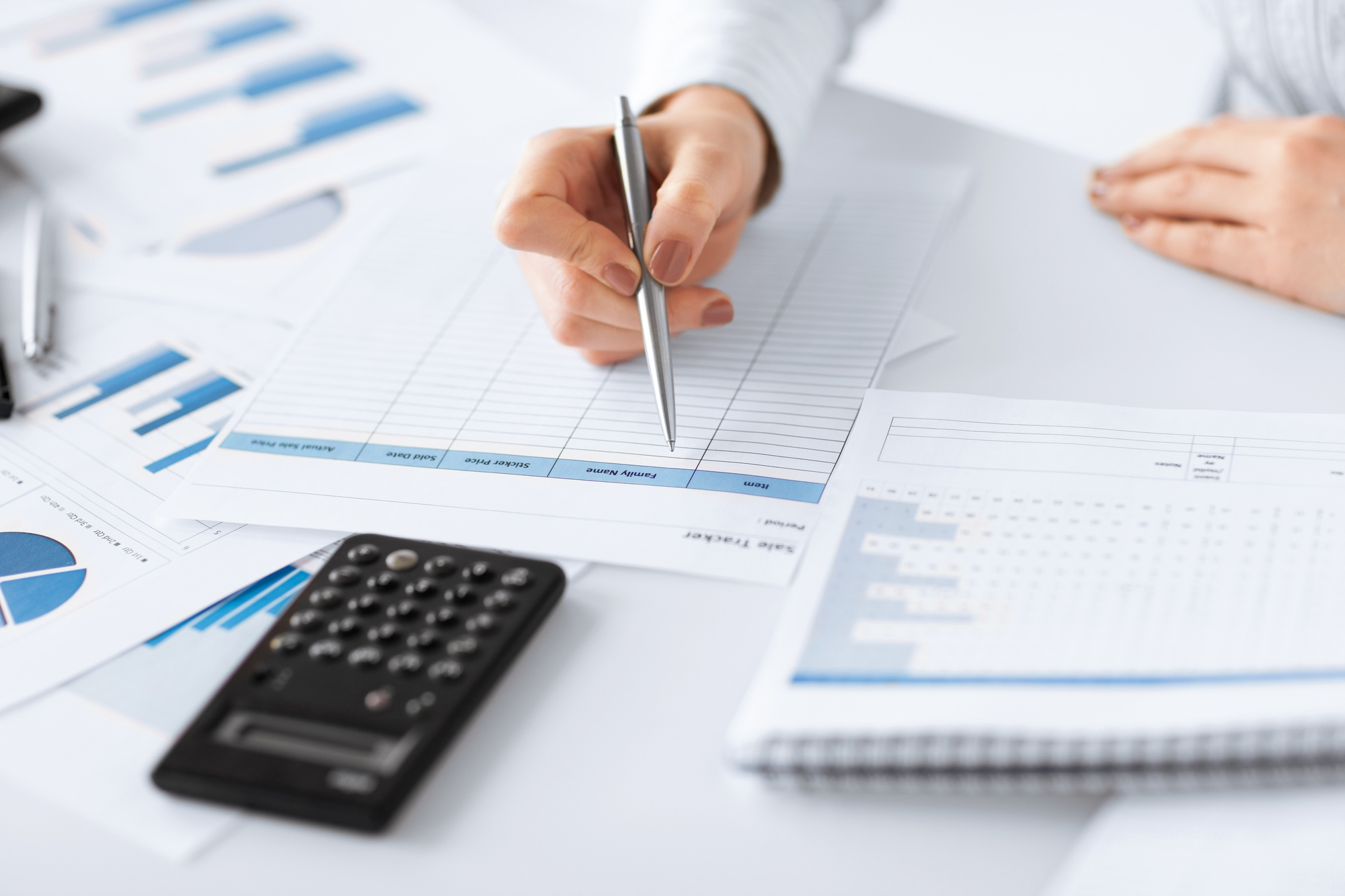 woman with hand doing bookkeeping